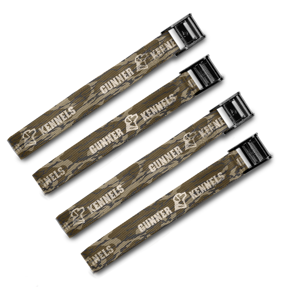 Four GUNNER TIE-DOWN STRAP KIT straps with a camouflage pattern, white GUNNER branding, and crash test certification are displayed parallel on a light background—perfect for securing your dog crate.