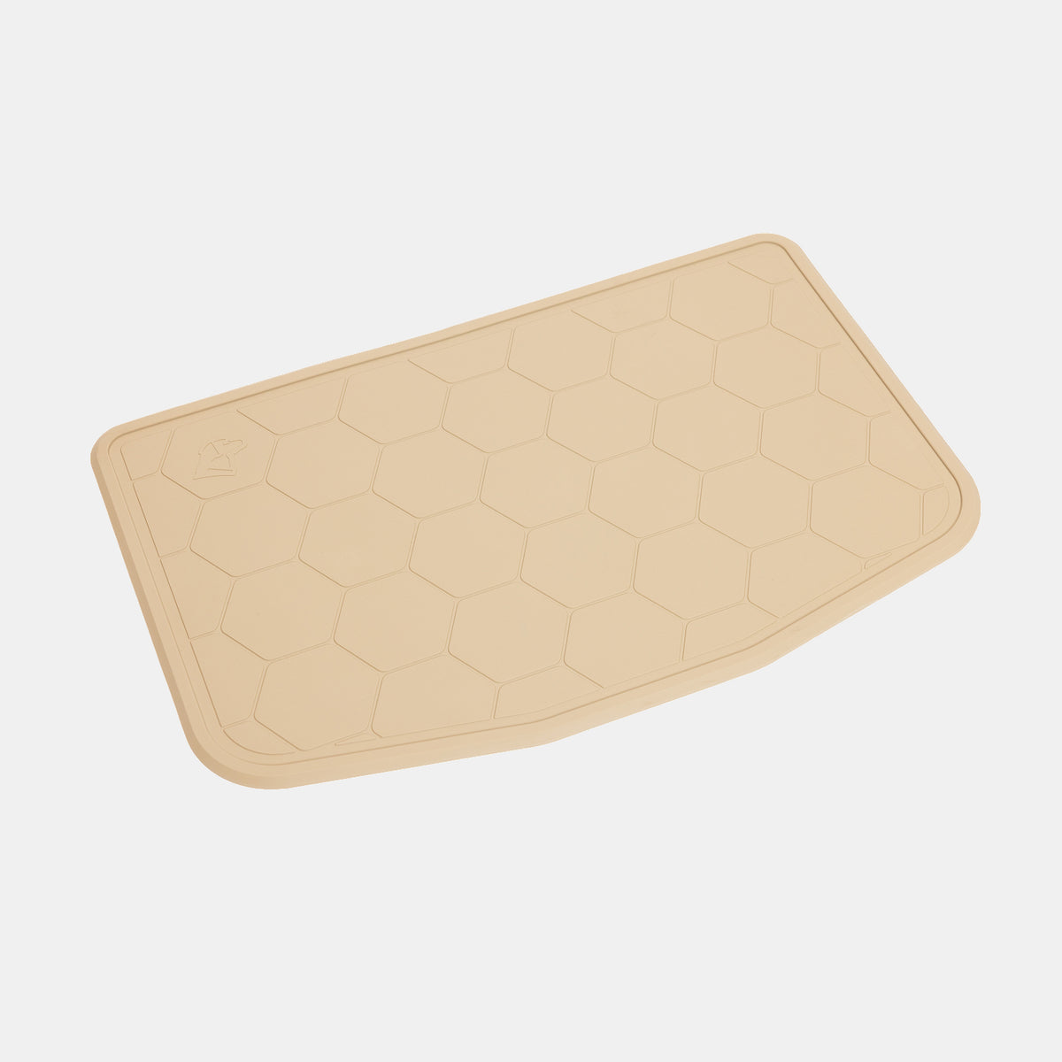 The GUNNER BOWL MAT - TAN is a beige, rectangular mat with rounded corners and a distinctive hexagonal pattern. Designed to be slip-resistant, it features a subtly uneven edge on one side and a small raised GUNNER icon in one corner. Dishwasher-safe for easy cleaning, the mat is pictured against a plain white background.