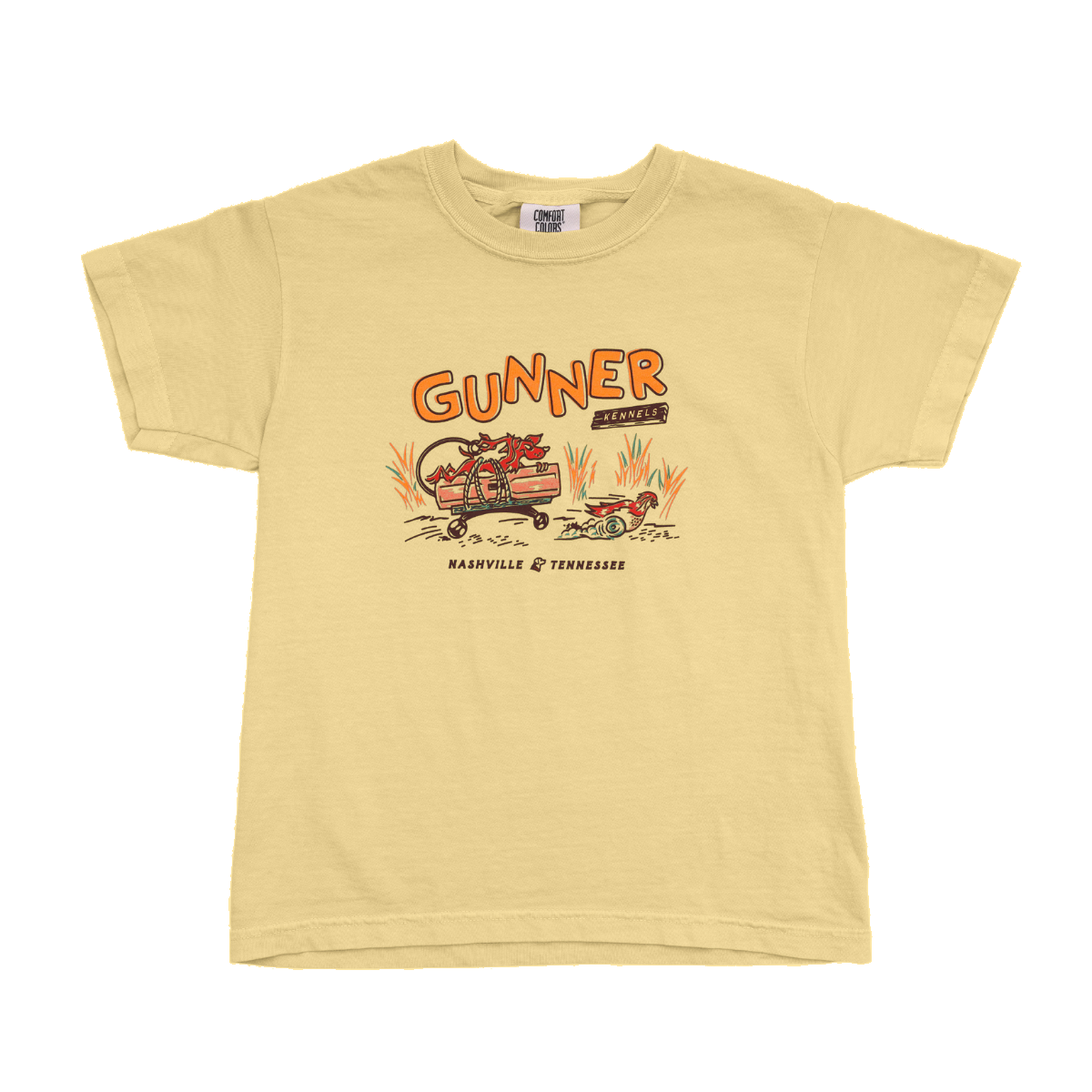 The BUMPER DYNAMITE TEE (Kids) by GUNNER features a light yellow design with a red dragon on a motorcycle, bold orange GUNNER lettering, and Nashville Tennessee below—perfect for young trendsetters and Road Runner fans.
