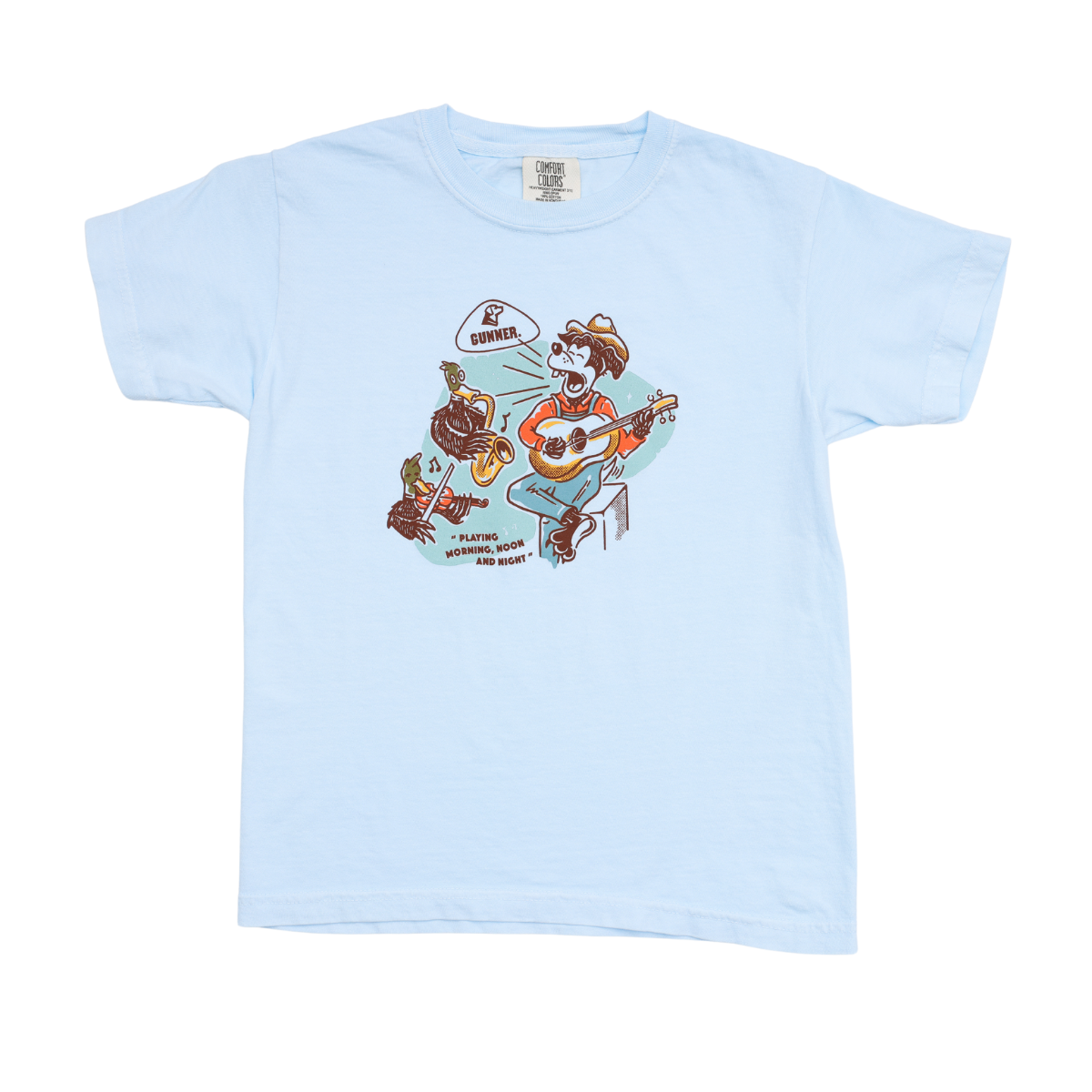 The GUNNER DOG & DUCK BAND TEE (Kids) is a light blue shirt with a cartoon dog in sunglasses and hat playing guitar beside a turtle at a campfire, “Summer” sign, and the text: “Playing for food and money.” Inspired by Broadway honky tonk vibes.