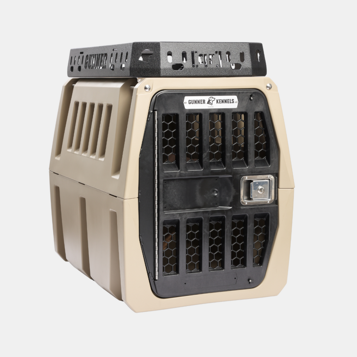 A tan and black hard-sided pet kennel with ventilation slats and a metal locking door, designed for safe animal transport, is compatible with the GUNNER Kennel Rack BLACK for secure placement in a truck bed or integration into a versatile storage system.