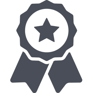 A dark gray icon of an award ribbon with a star in the center and two ribbon tails hanging down, set against a light background—perfect for recognizing your working dogs achievements or top outdoor gear.