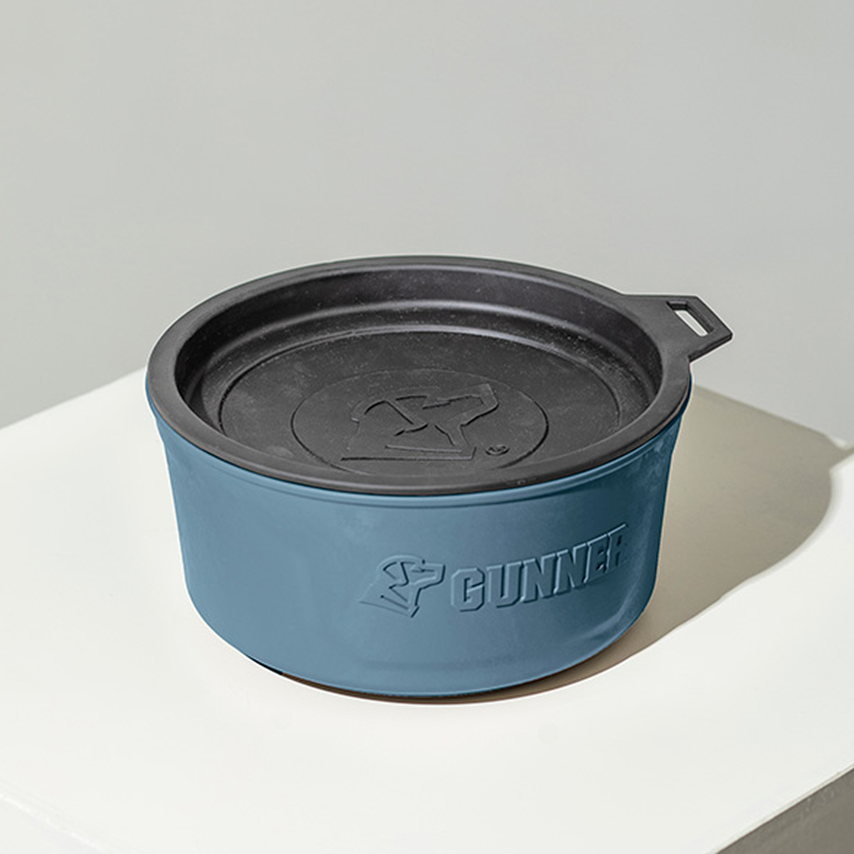 The GUNNER DOG BOWL - Ducks Unlimited Blue by GUNNER is a blue and black round bowl with a lid, featuring the GUNNER name and dog logo—ideal for any Ducks Unlimited or waterfowl habitat enthusiast.