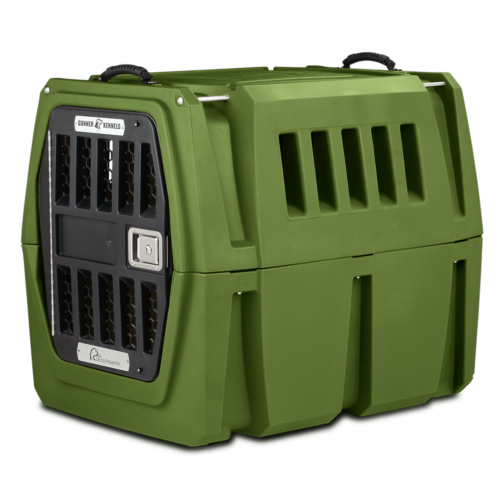The GUNNER G1™ Kennel by GUNNER is a durable green double-walled plastic crate with vented sides, metal door, and top handles for secure pet transport. Shown on a plain white background.