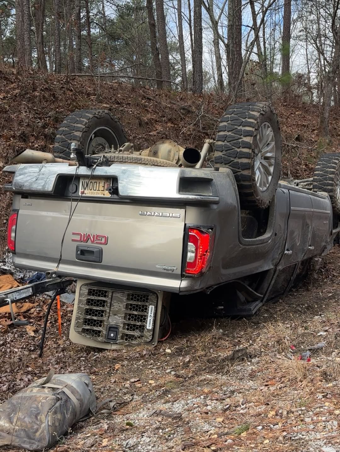 Truck upside down on the side of the road. Truck was towing a boat and has a crash-tested G1™ Intermediate Kennel in the bed.
