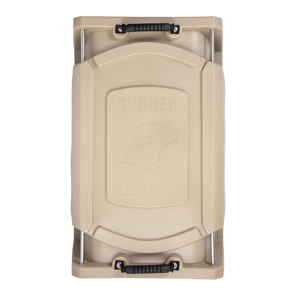 Top view of GUNNER’s tan, double-walled G1™ KENNEL with black handles, featuring a raised dog head logo and GUNNER branding on the lid—renowned as the safest pet crate.
