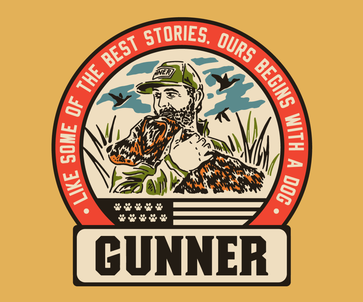 A bearded man in a hat hugs a working dog with birds flying in the background. Text reads: LIKE SOME OF THE BEST STORIES, OURS BEGINS WITH A DOG. Below, there’s a stylized American flag and the word GUNNER.