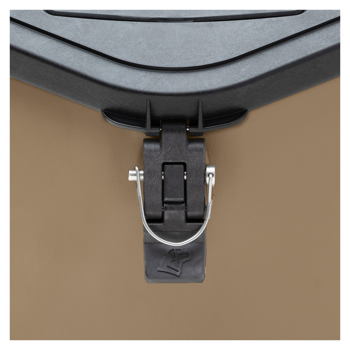 Close-up of a black plastic and metal latch securing the lid of the GUNNER FOOD CRATE - Cheyenne Bottoms by GUNNER, a tan durable pet food container, with a simple lock symbol embossed on the latch.