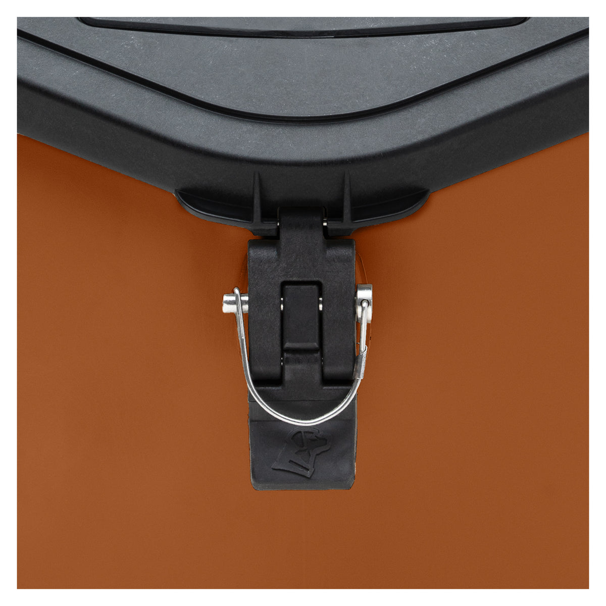 Close-up of a black latch mechanism with a metal pin securing the lid of an orange dog kennel or cooler.