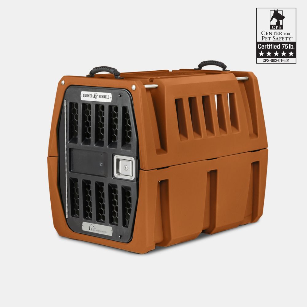 The GUNNER G1™ KENNEL - Ducks Unlimited Orange is a sturdy double-walled kennel with an orange body, black ventilated door, two top handles, and a Center for Pet Safety label as the safest crate for pets up to 75 lbs.