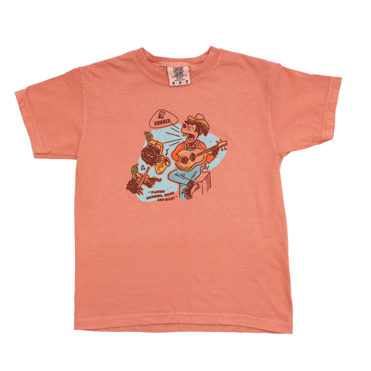 The GUNNER DOG & DUCK BAND TEE (Kids) is a peach tee with two animals in hats playing guitars and a speech bubble, “Please honk if you want more music!”—adding Honky Tonk fun to any kid’s style.
