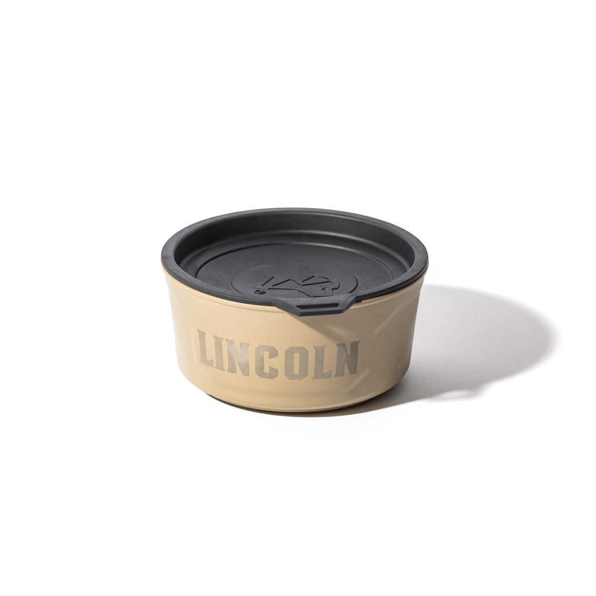 The GUNNER DOG BOWL - TAN by GUNNER is a beige dog bowl with a black lid and bold gray branding, shown on a white background.