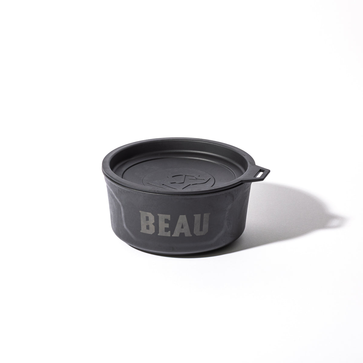 The GUNNER DOG BOWL - BLACK by GUNNER is a travel dog bowl with a lid, displaying BEAU in large letters on the side and casting a soft shadow against a white background.