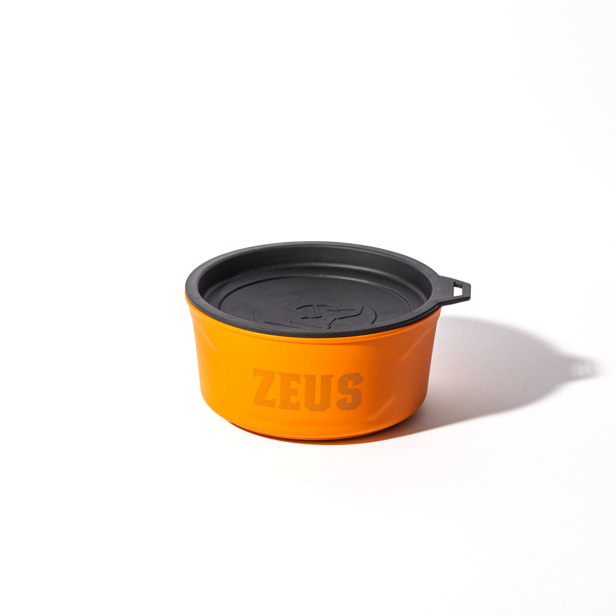 The GUNNER DOG BOWL - BLAZE ORANGE by GUNNER features a vibrant orange bowl with a black lid and ZEUS on the side, from the Color Fetch collection, shown on a white background with a right-side shadow.