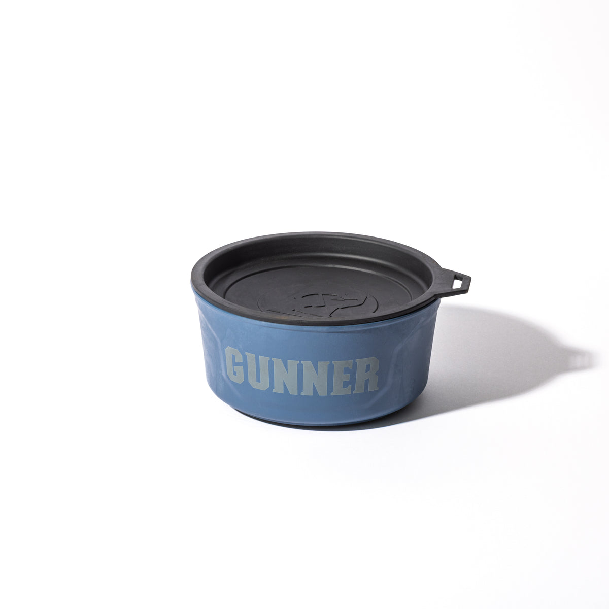 The GUNNER DOG BOWL - Ducks Unlimited Blue by GUNNER, featuring a black lid with a small tab and bold white GUNNER lettering, rests on a white surface—ideal for any passionate Ducks Unlimited supporter.