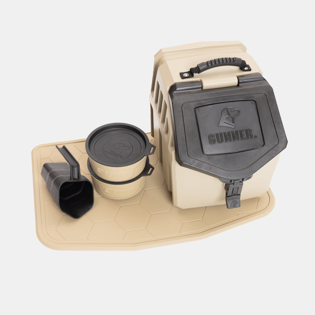 The gunner.momplete Food & Water Bundle, featuring a tan and black pet food storage container with a handle, two stackable dog bowls, a scoop, and a matching bowl mat, is arranged on a light background.