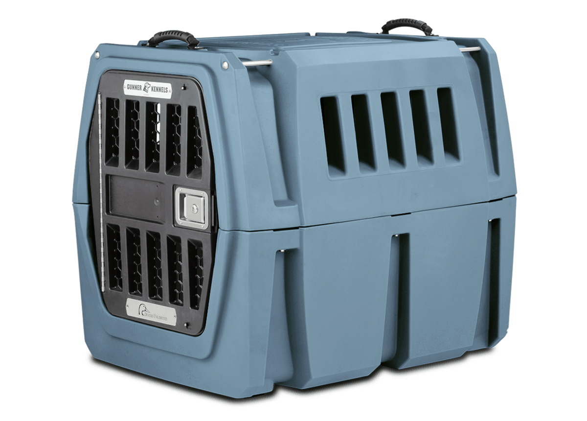 The GUNNER G1™ Kennel is a blue and black double-walled crate with ventilation slats and a metal front door, designed by GUNNER for top shock protection when transporting animals.