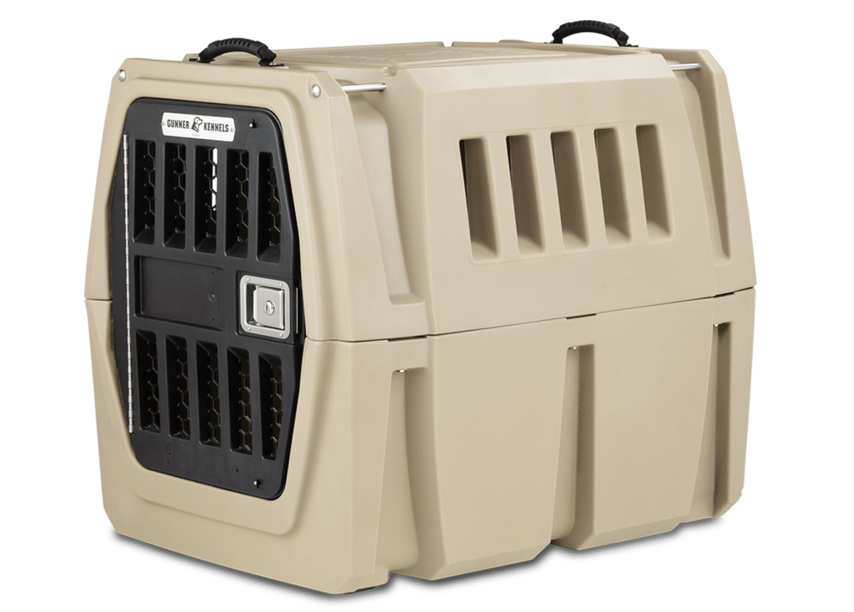 The GUNNER G1™ Kennel features a tan, double-walled design with ventilation slats and a secure black metal-barred front door, offering shock protection for safe pet transport—making it one of the safest crates by GUNNER.