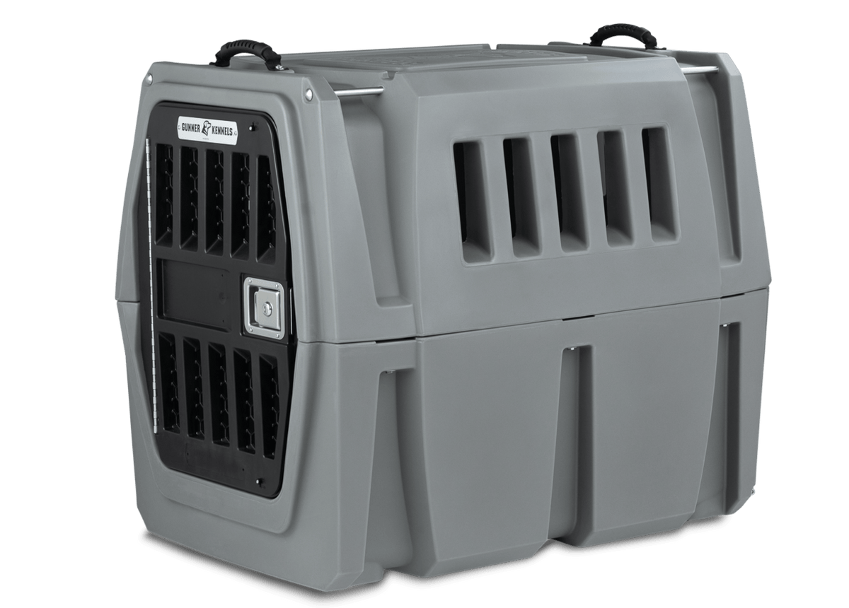 The GUNNER G1™ Kennel by GUNNER YARD is a sturdy gray double-walled crate with side ventilation slits, a metal grid front door, and black top handles for shock protection—making it one of the safest options for your dog.
