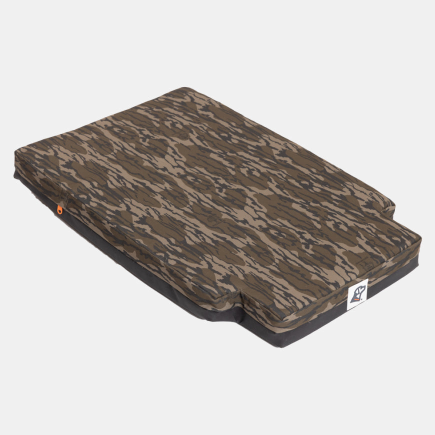 Rectangular dog bed with a camouflage-patterned cover and a notch at one end, ideal for a hunting dog or kennel use, set on a plain white background.