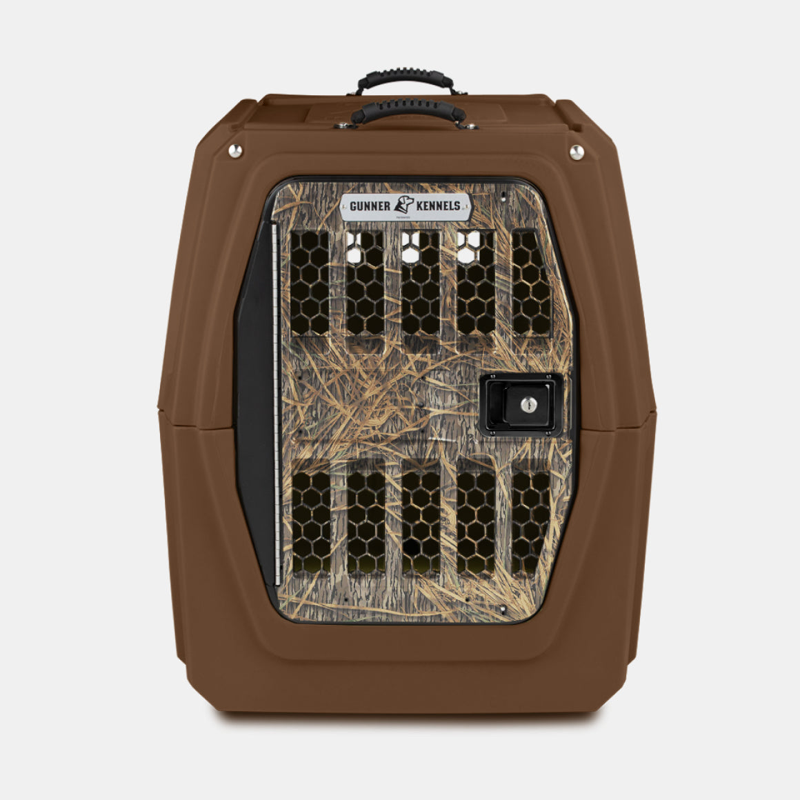 The GUNNER G1™ KENNEL - SUSQUEHANNA/MOSSY OAK SHADOW GRASS is a brown hard-sided pet crate with a Mossy Oak pattern door, multiple vents, and a secure latch—ideal for duck & goose hunters transporting pets safely.