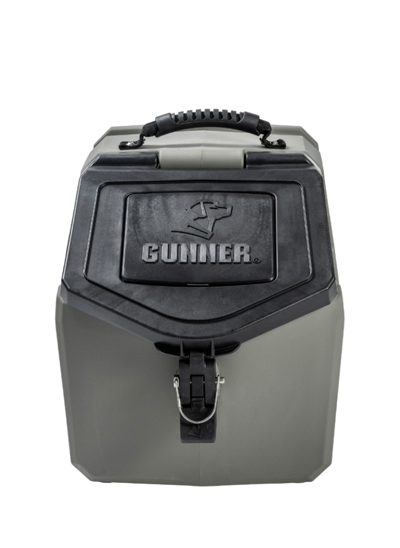 A gray, hard-sided dog kennel with a sturdy handle on top, a secure latch in front, and the brand name GUNNER embossed on the door—ideal for transporting your working dog safely.