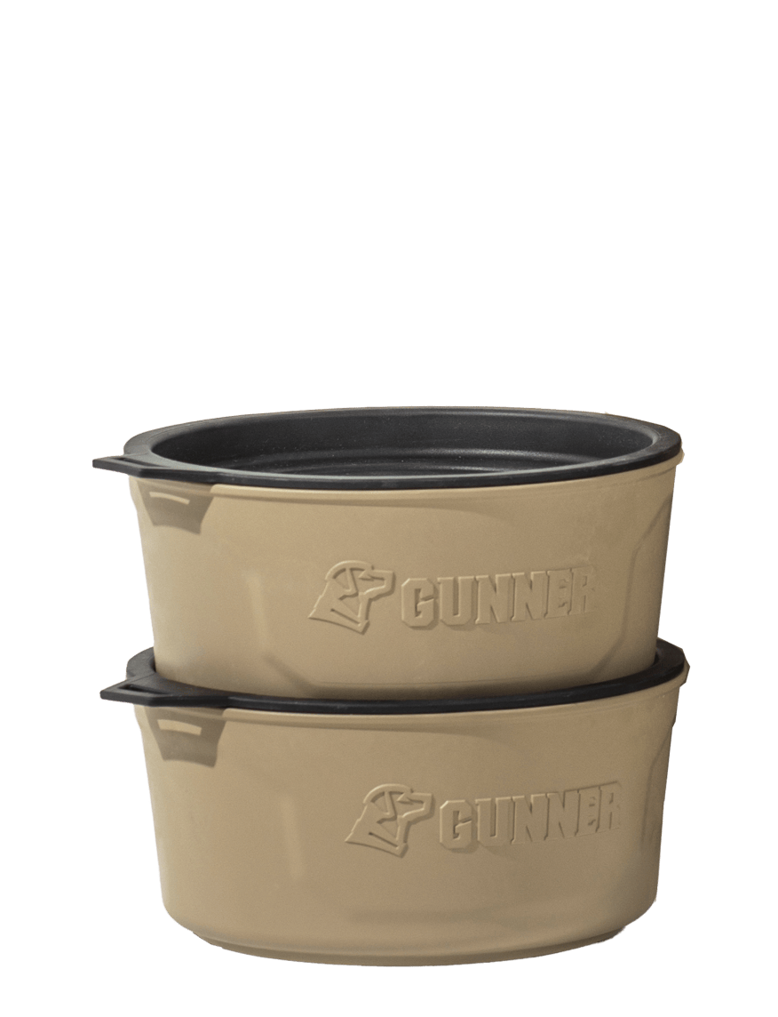 Two tan-colored, stackable bowls with black interiors and handles, each featuring the word GUNNER and a dog logo embossed on the side—perfect for your hunting dog’s outdoor gear, shown against a plain white background.