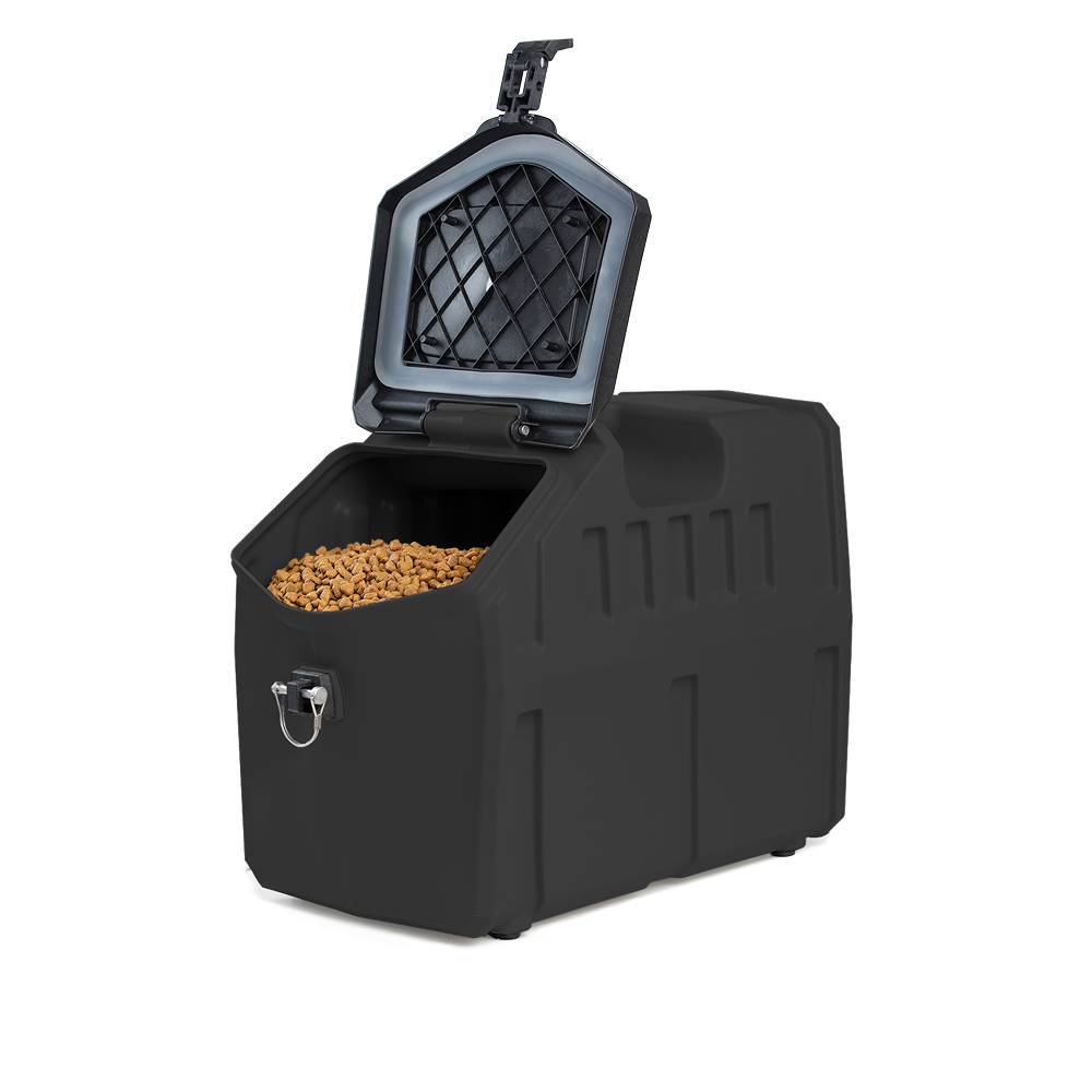 The GUNNER FOOD CRATE - Black by GUNNER is a rectangular dog food storage container with an open lid, showing dry kibble inside. It features a front metal latch and a textured inner lid for odor-proof protection.