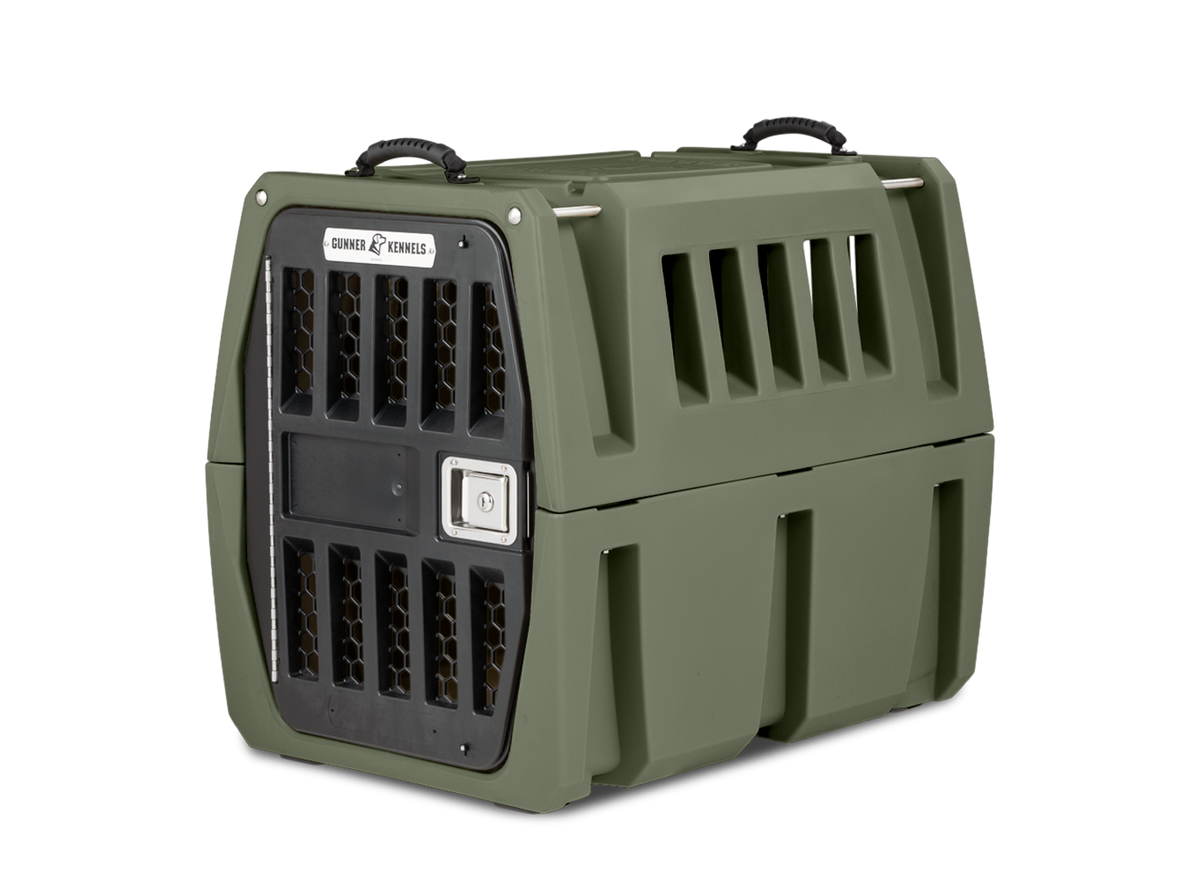 The GUNNER G1™ Kennel in Gunner Green features double walls, ventilation slats, a metal locking front door, and two top carrying handles. This sturdy crate is designed for safe pet transport and is among the safest dog crates available.