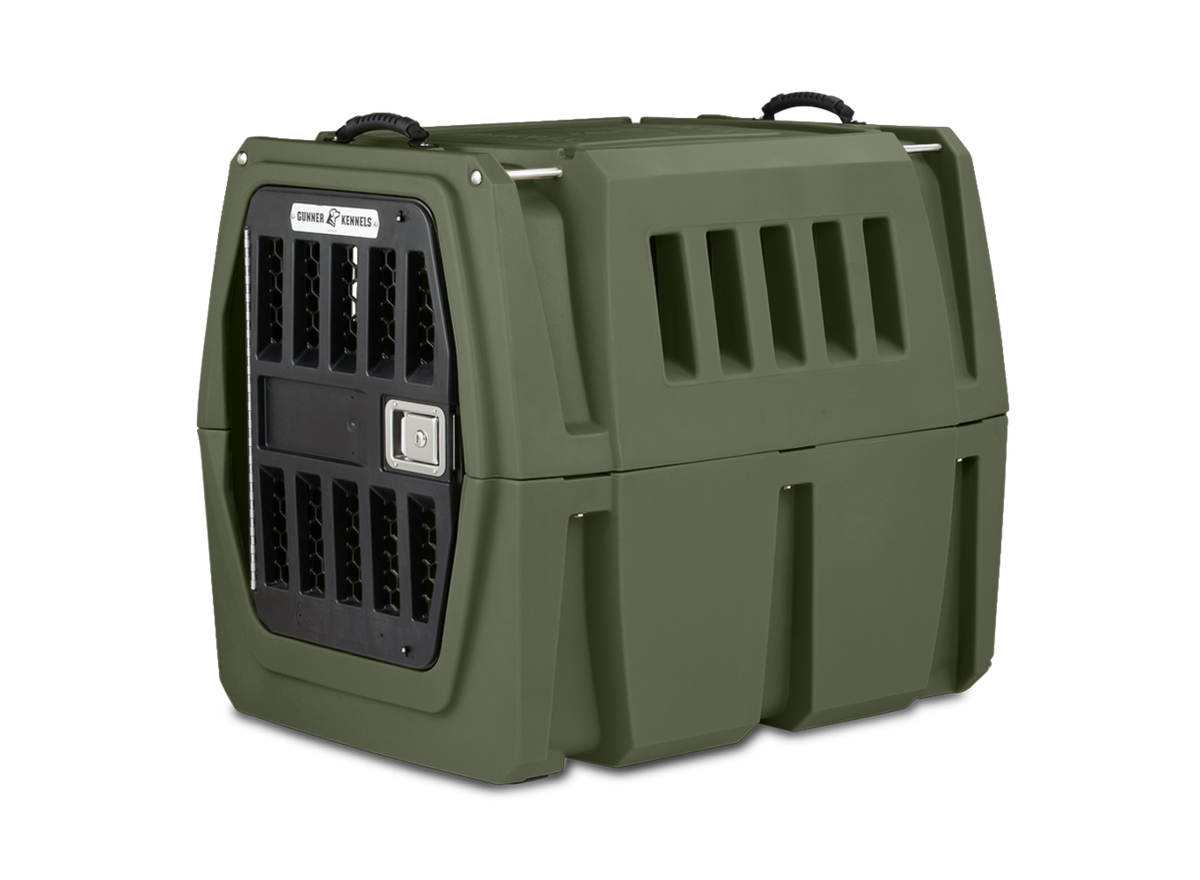 The GUNNER G1™ KENNEL in Gunner Green is a sturdy, double-walled dog crate with ventilation slats, a secure metal door, and top carrying handles—designed for the safest animal transport.