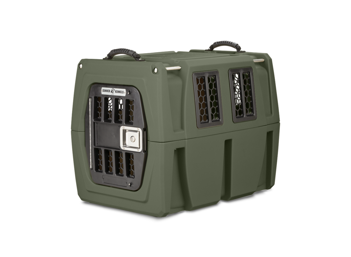 The GUNNER G1™ KENNEL in Gunner Green features double-wall construction, black metal vents, a silver latch, and two black handles—one of the safest American-made dog crates.