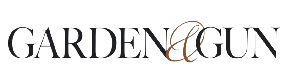 The words GARDEN & GUN in capital black letters, with an elegant brown ampersand connecting the words—evoking the classic style of a hunting dog kennel or finely crafted dog crate.