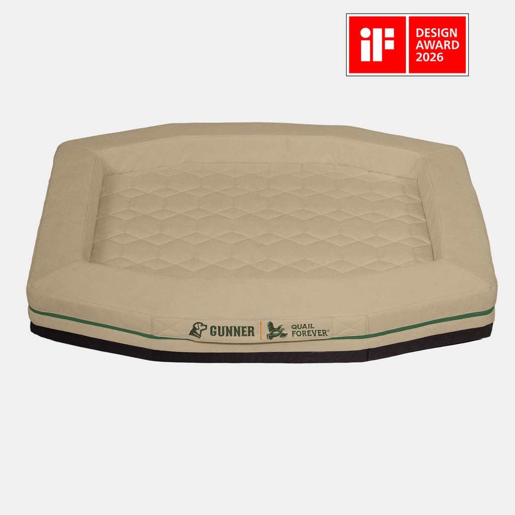 A tan, hexagonal HOMESTEAD DOG BED Quail Tan by GUNNER features quilted padding, easy-to-clean fabric, and a stylish design. Displayed on a light gray background with a red iF Design Award 2026 badge in the top right corner.