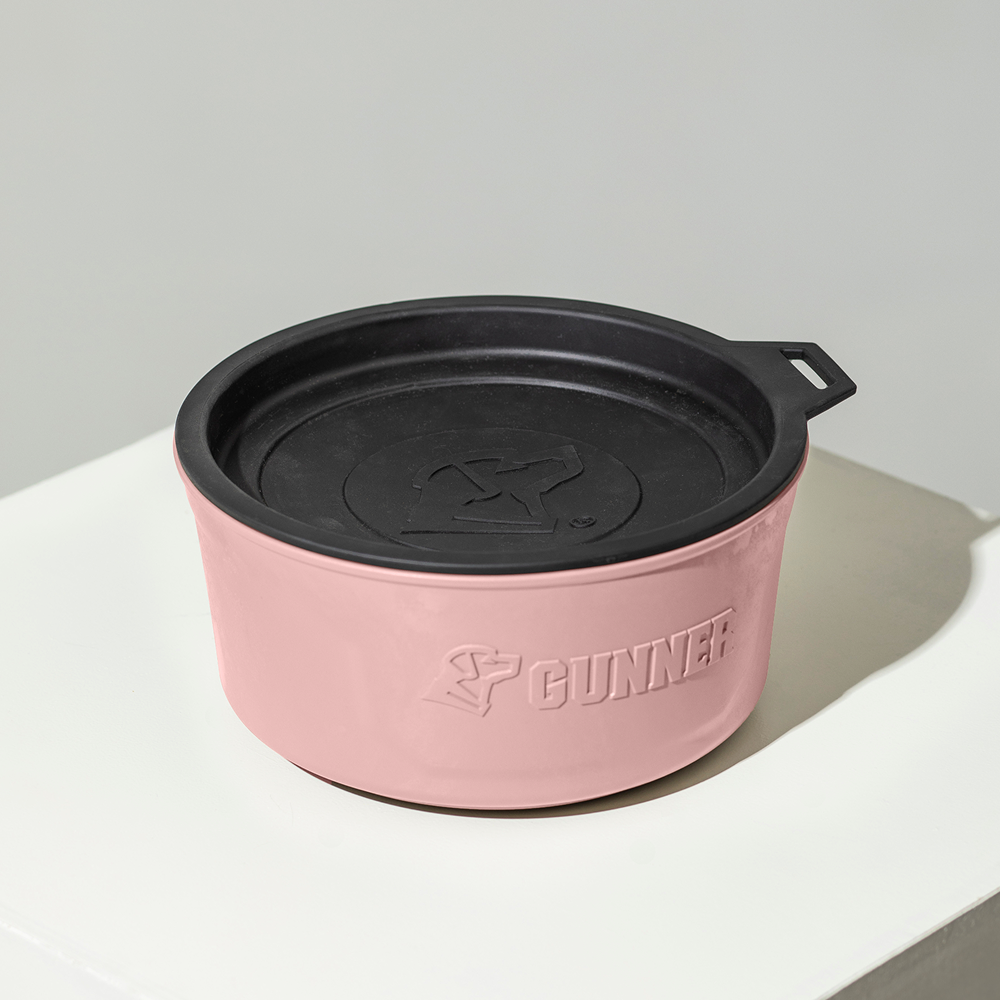 The GUNNER DOG BOWL - Pink is a limited edition travel bowl with a black lid, raised logo, and GUNNER embossed alongside a dog silhouette—perfect for stylish pups on the go.