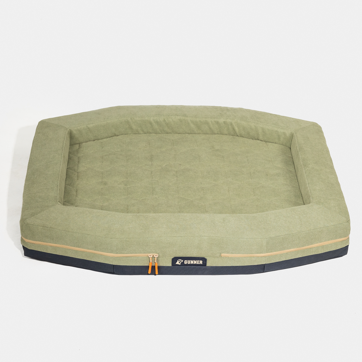 The HOMESTEAD DOG BED Treeline Green by GUNNER is a durable olive green rectangular dog bed with raised edges, quilted surface, front zipper, and black GUNNER label, shown on a white background. Easy to clean for everyday use.