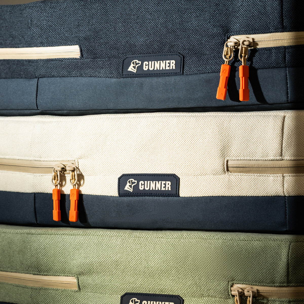 Close-up of the GUNNER HOMESTEAD DOG BED in Harbor Blue—featuring an overbuilt, easy-to-clean fabric design and bright orange zipper pulls for everyday durability.