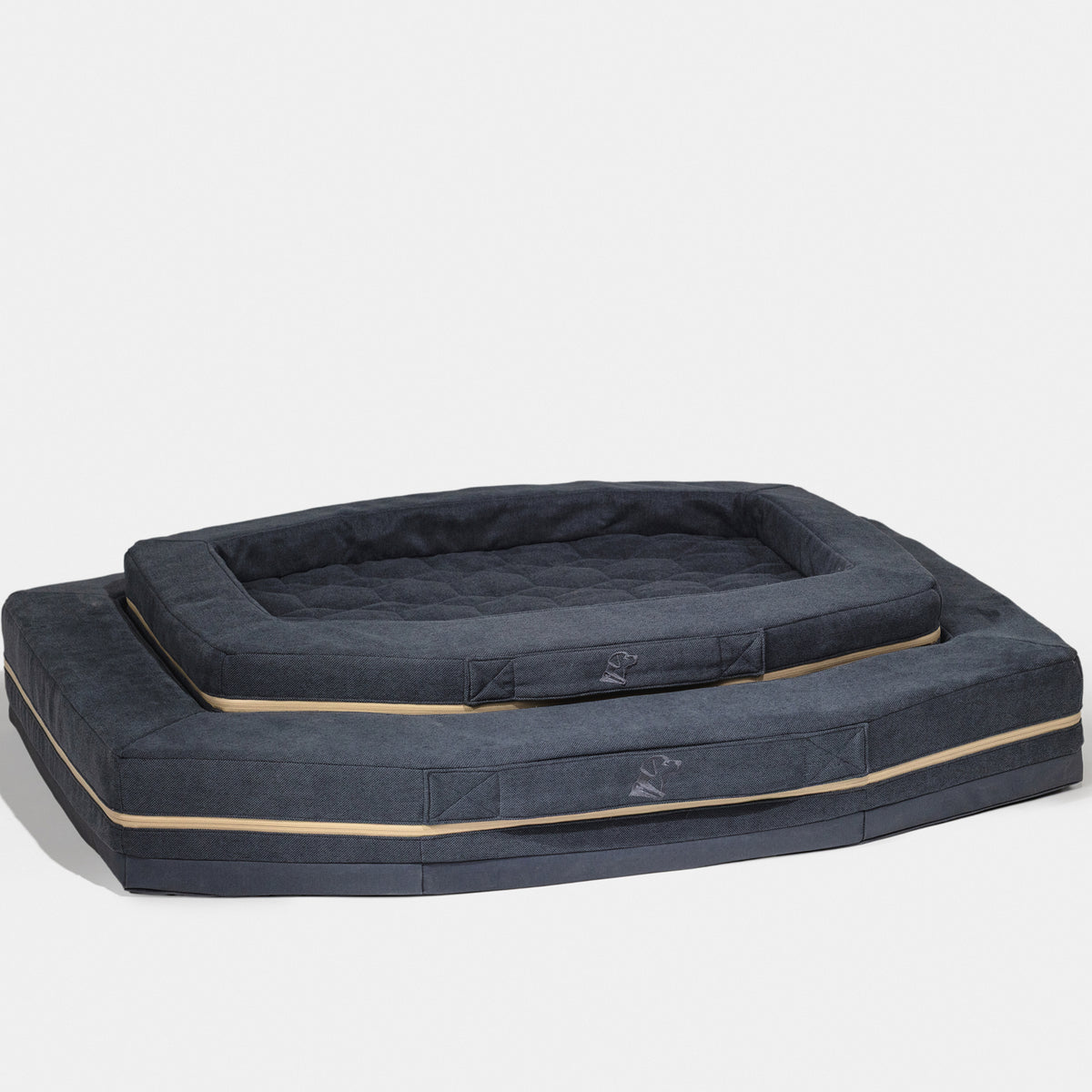 Two harbor blue rectangular GUNNER HOMESTEAD DOG BEDS, one smaller stacked on a larger one, both with beige trim and padded sides. Durable, easy to clean, and comfy for your pet—all set against a plain white background.