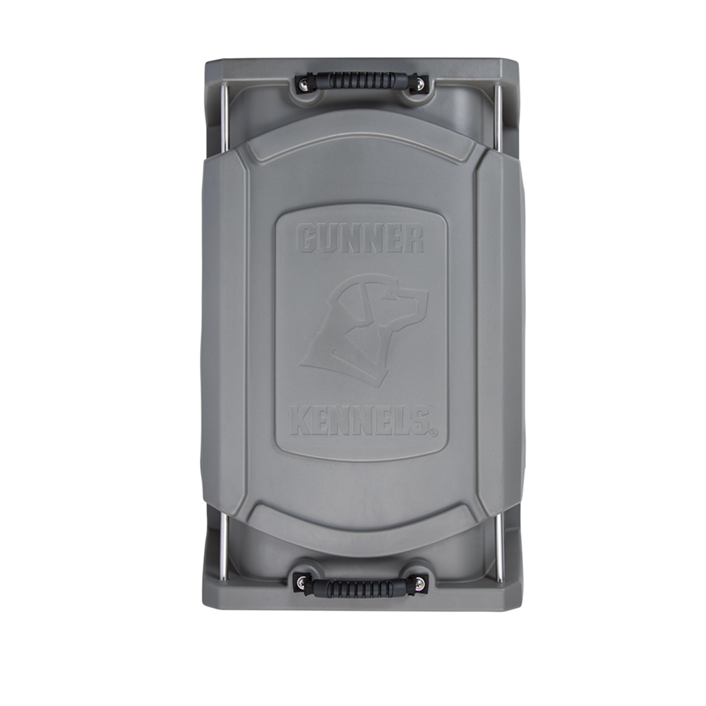 Top view of the G1™ KENNEL - GUNMETAL dog crate lid by GUNNER, made of durable gray plastic with black handles, featuring an embossed dog head logo and the GUNNER name on the surface.