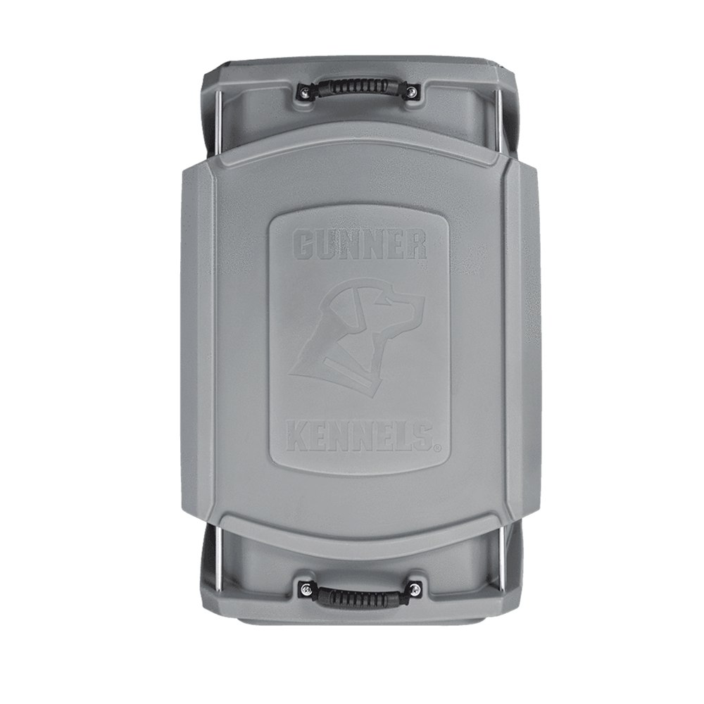 The GUNNER G1™ KENNEL in gunmetal is a hard-sided, durable dog crate with molded handles and an embossed dog head logo on the lid, designed for safety and strength.