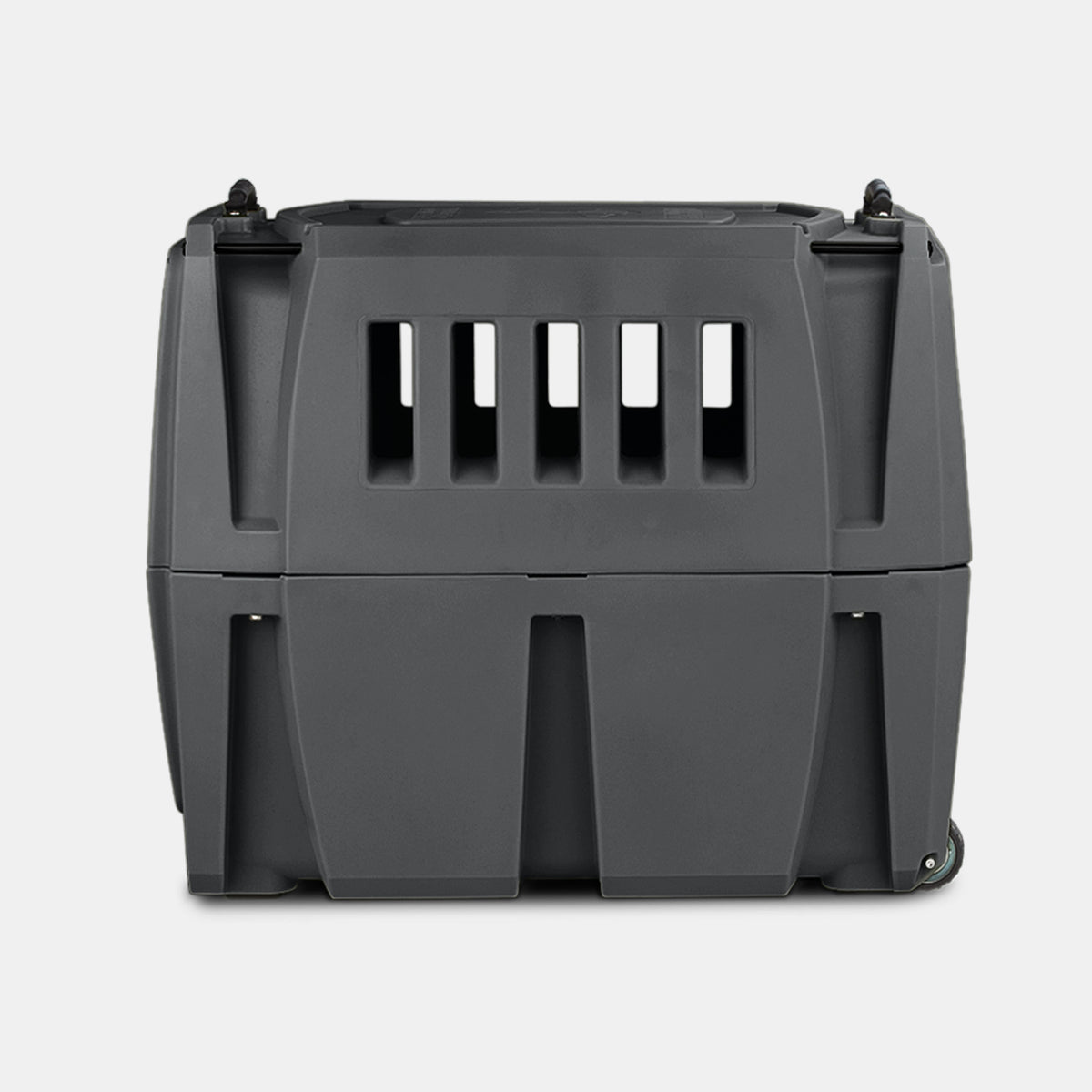 A sturdy, dark gray plastic dog crate with ventilation slats on the front, secure latches on top, and wheels on the bottom right corner. The carrier is placed against a plain light gray background.