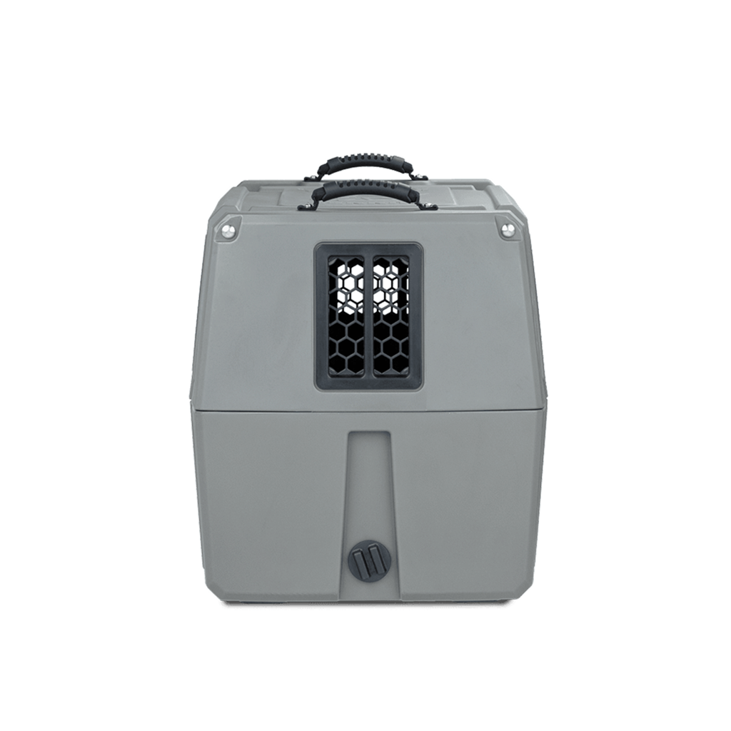 The GUNNER G1™ KENNEL - GUNMETAL is a gray, rectangular dog crate with a central black mesh window and top handle, shown against a white background.