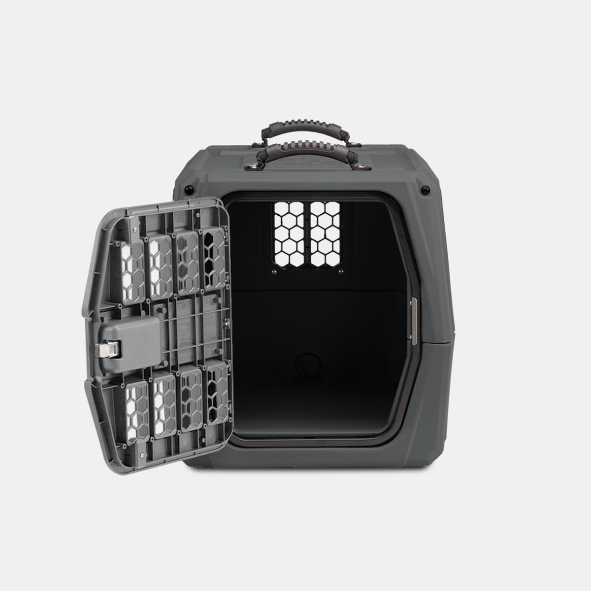 A gray, hard plastic pet carrier designed as a convenient dog kennel, with a textured handle and an open metal door, shown on a plain white background. The carrier is empty and has a small window with holes on the back.