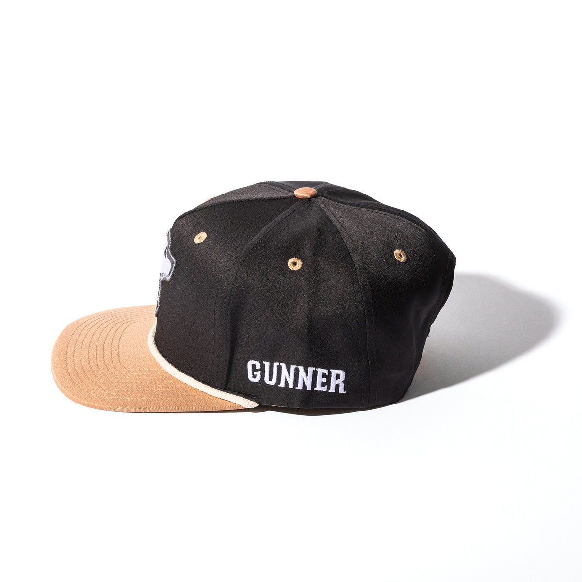The GUNNER HUNT SOLIDS Rope Hat is a black and tan snapback cap featuring GUNNER embroidered in white on the side, displayed on a white background—ideal for fans of hunt solids style.