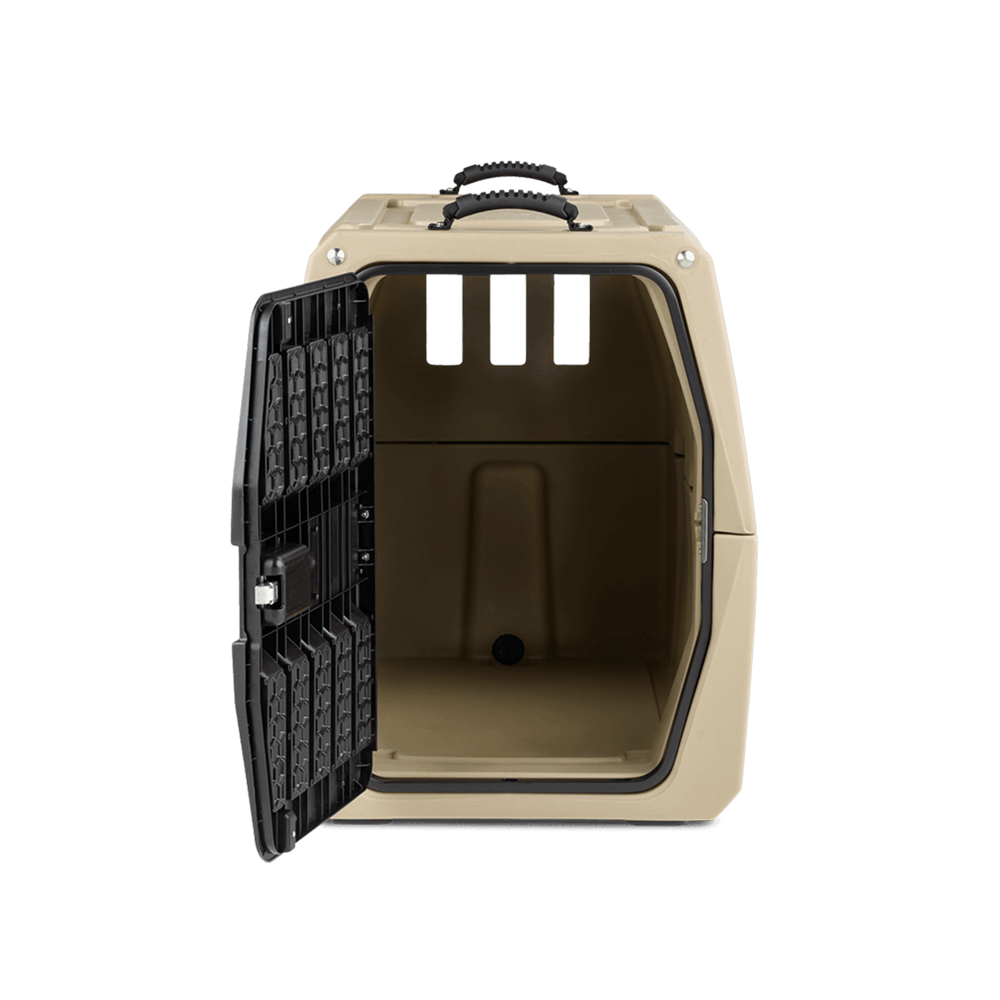 The GUNNER G1™ KENNEL - MOSSY OAK BOTTOMLAND TAN is a beige, hard-sided dog crate with a black metal door opening to the left, revealing an empty interior and three rectangular ventilation openings at the back.