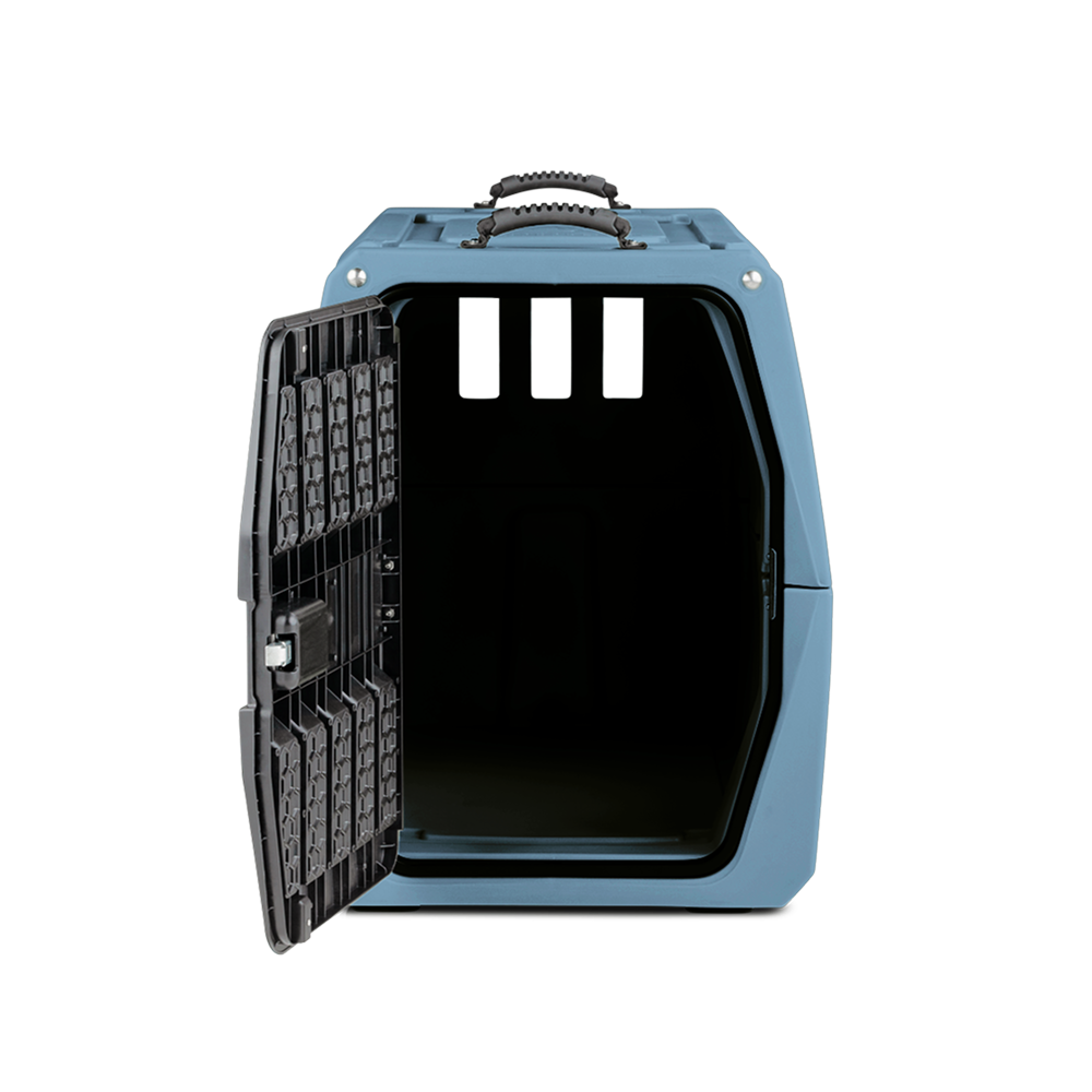 A GUNNER G1™ KENNEL - Ducks Unlimited Blue pet carrier with a handle is shown open, revealing a dark interior. The front side features three rectangular ventilation holes and a black metal door.