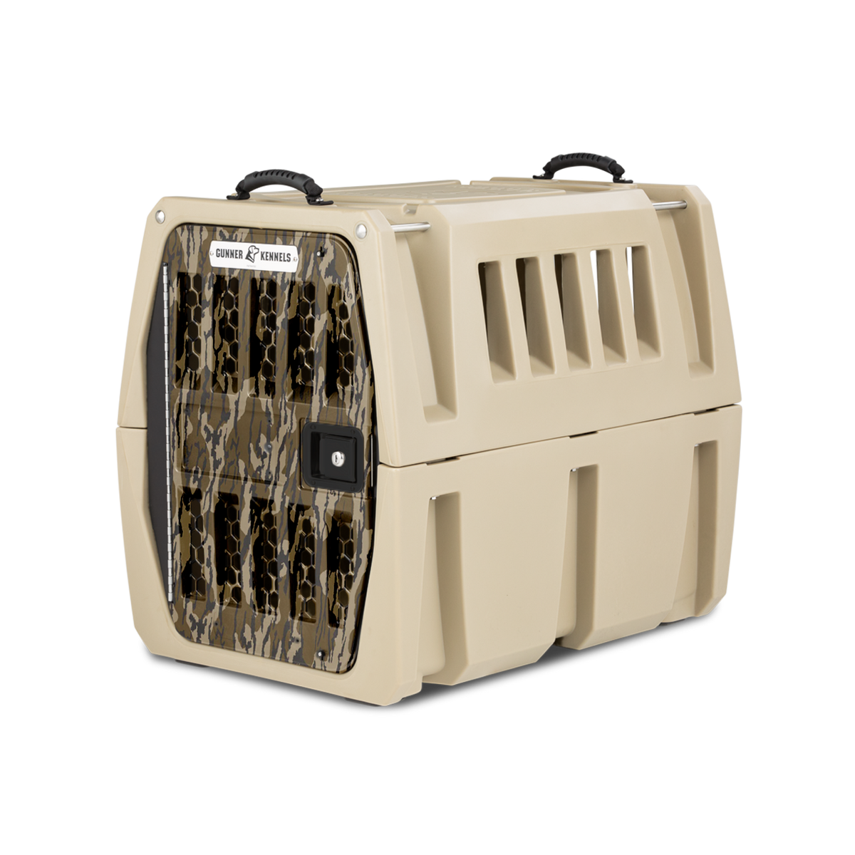 The GUNNER G1™ KENNEL - MOSSY OAK BOTTOMLAND TAN is a tan, hard-sided dog crate with black handles and a camo-patterned door. It has side ventilation slats and a lockable door for safe, secure pet transport.