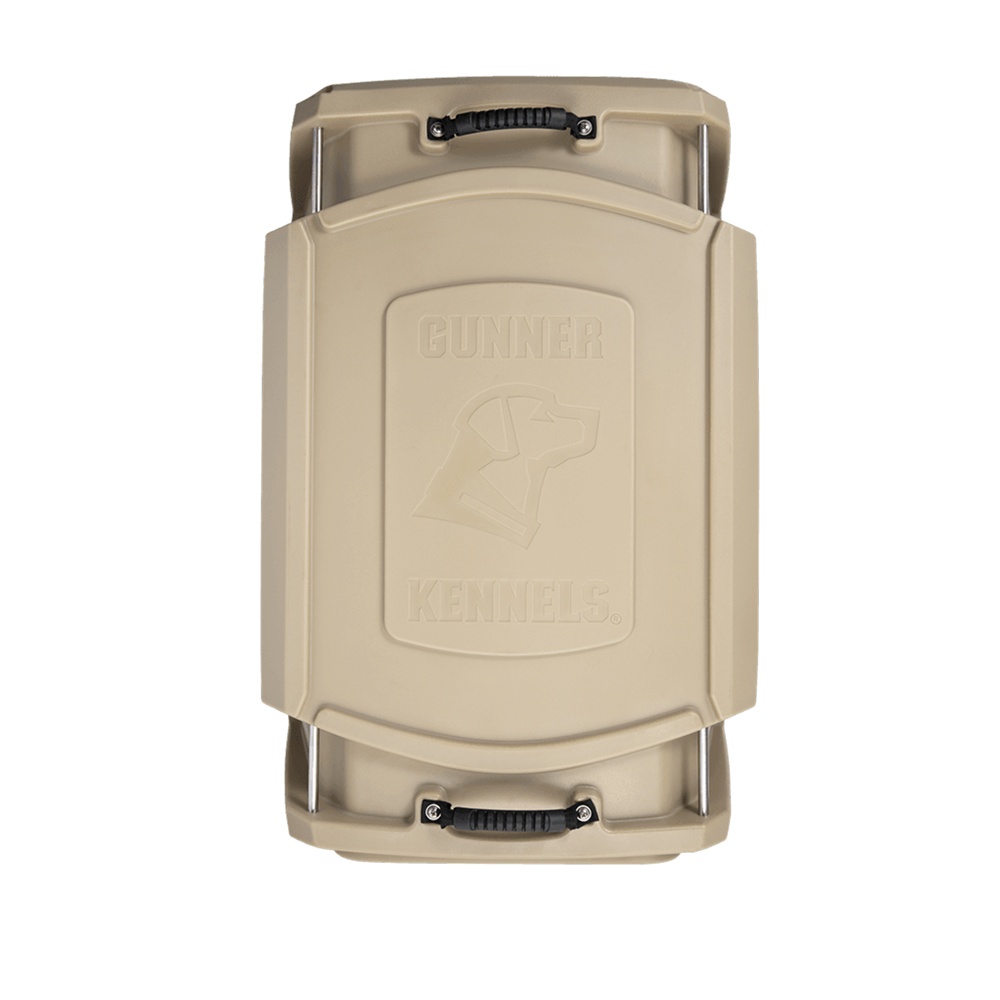 Tan rectangular dog crate lid with black handles at both ends. Features a raised dogs head outline and GUNNER logo, designed for the G1™ KENNEL - MOSSY OAK BOTTOMLAND TAN by GUNNER, built for durability and pet safety.