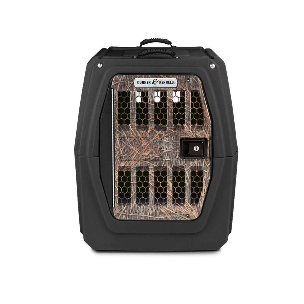 The GUNNER G1™ KENNEL in Black/Shadow Grass camo has a vented front door and durable build, making it one of the safest dog crates. Pictured against a plain white background.