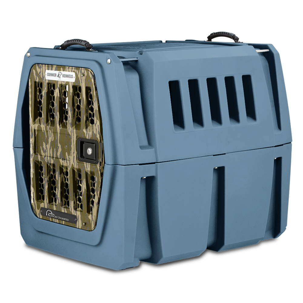 The GUNNER G1™ Kennel from GUNNER YARD is a sturdy, blue double-walled dog crate with a camo metal door, black top handles, side vents, and shock protection—engineered as one of the safest options for animal transport.