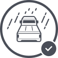 Icon of a car driving in the rain, depicted with diagonal lines for raindrops. The image is enclosed in a circle with a checkmark, suggesting safe or approved driving—perfect for those transporting outdoor gear or a working dog in wet conditions.